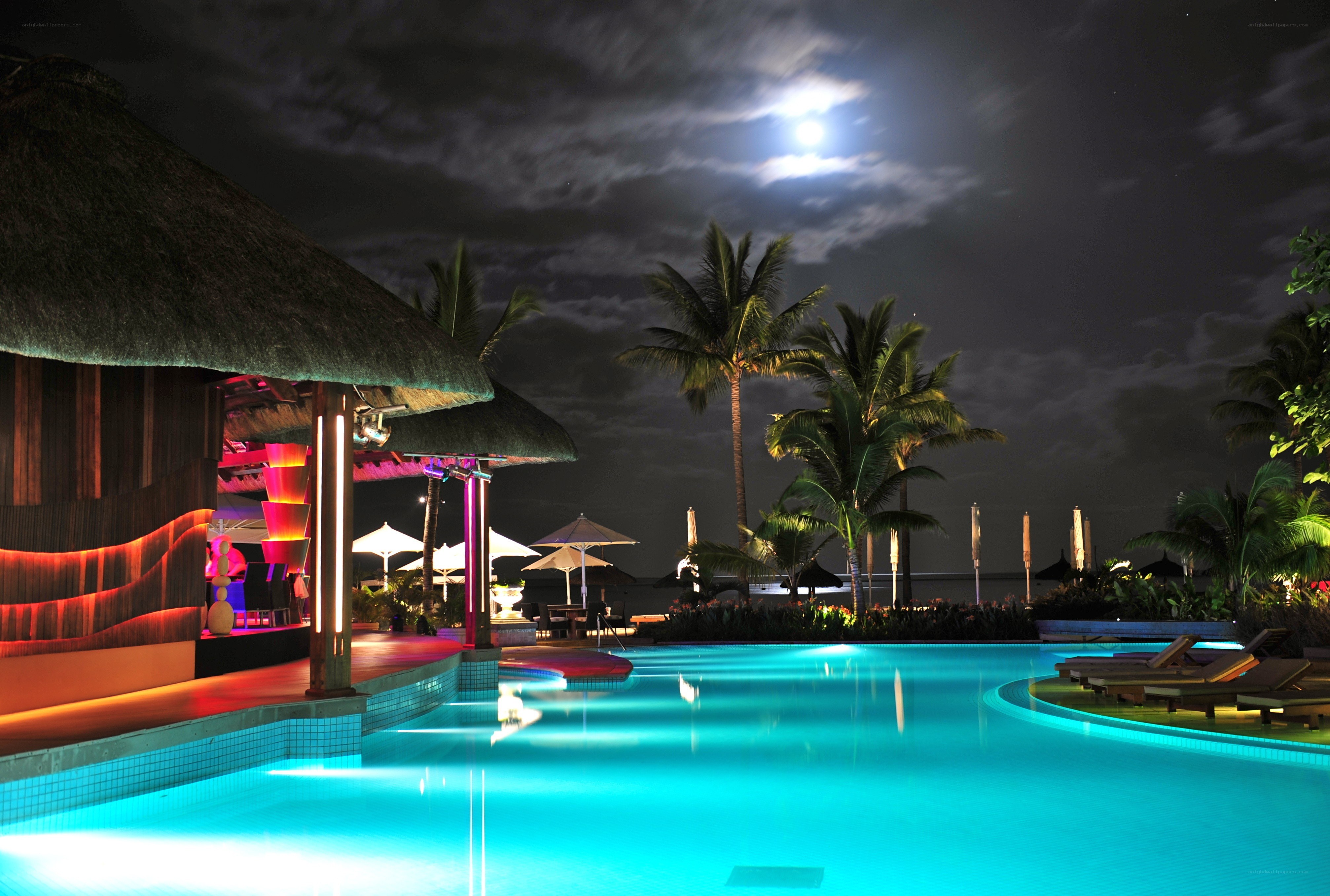 Nighttime pool at tropical resort
