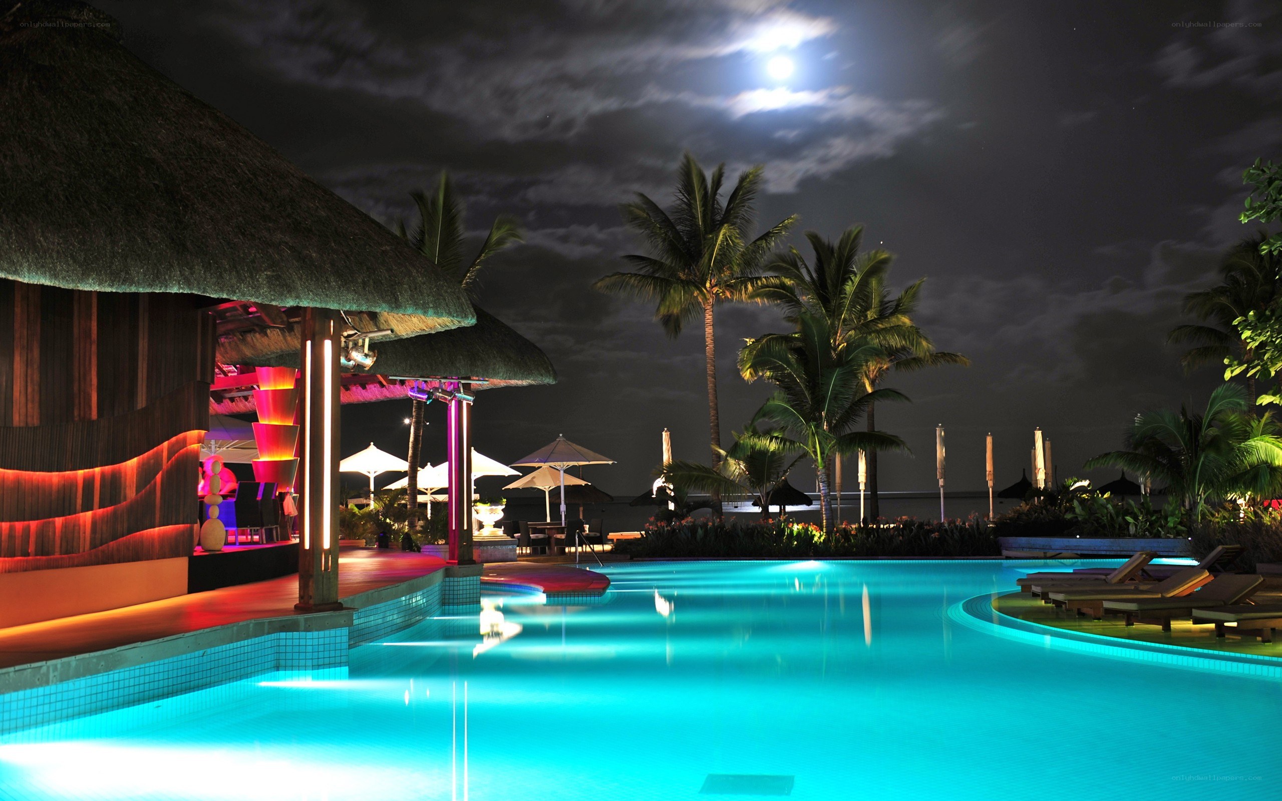 Nighttime pool at tropical resort