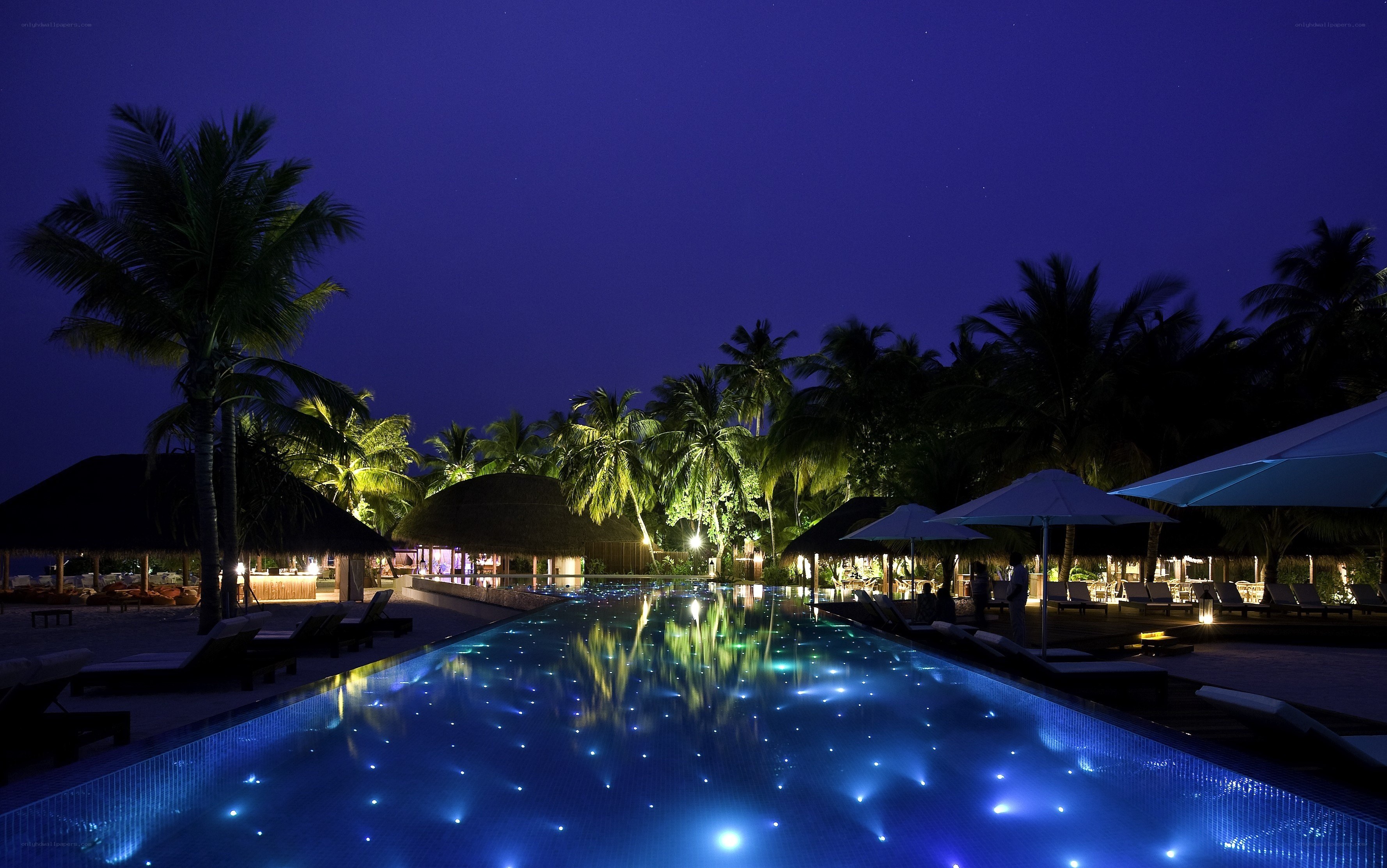 nighttime pool at tropical resort