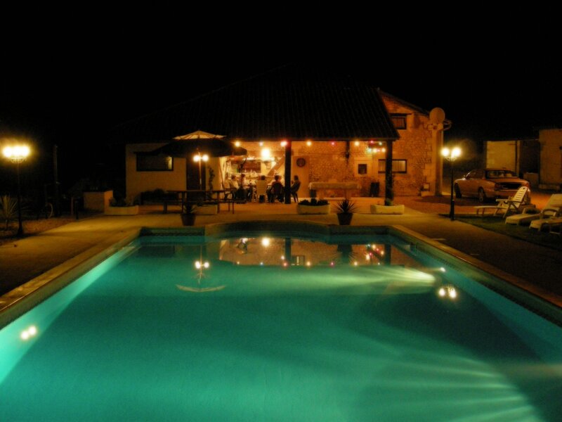 Nighttime pool scene at a villa