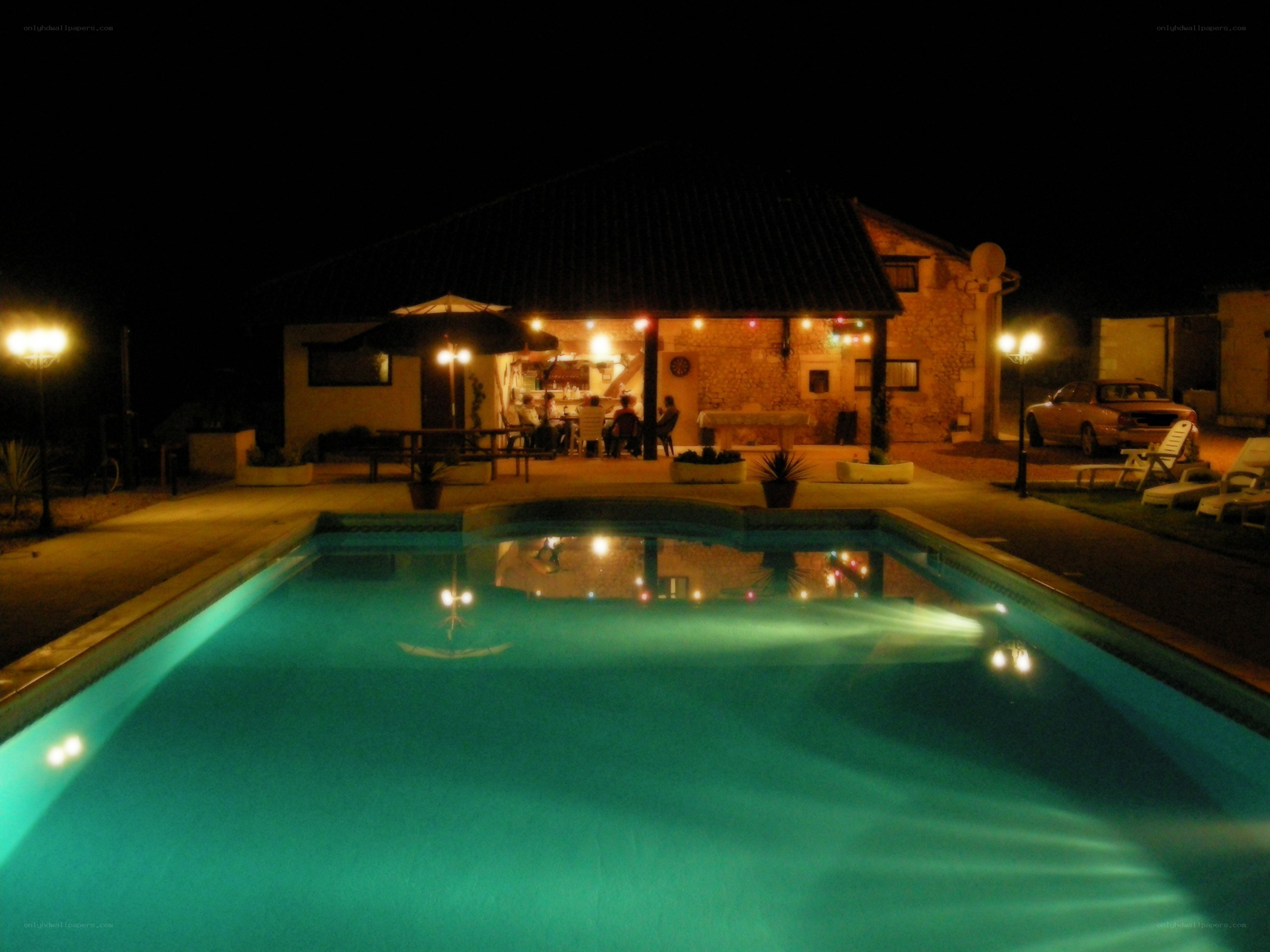 Nighttime pool scene at a villa