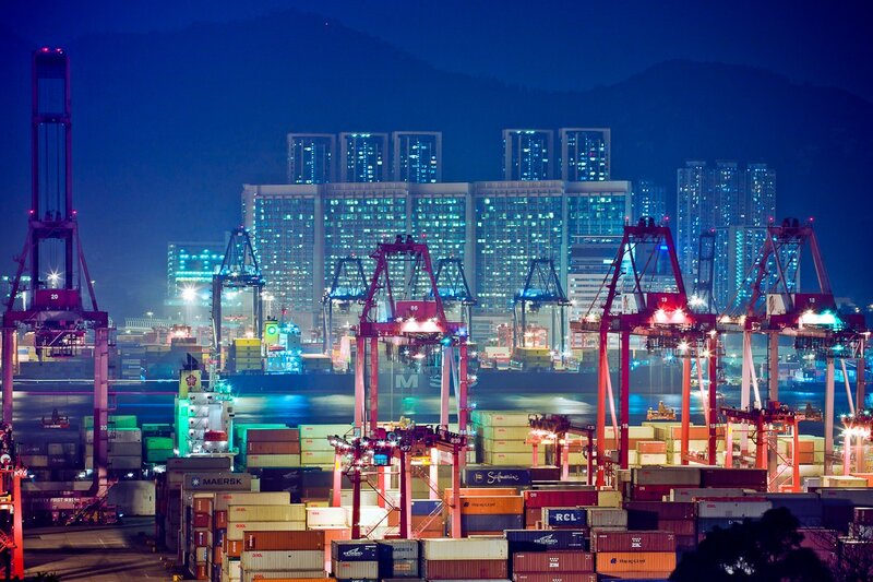 Nighttime port with cranes and containers