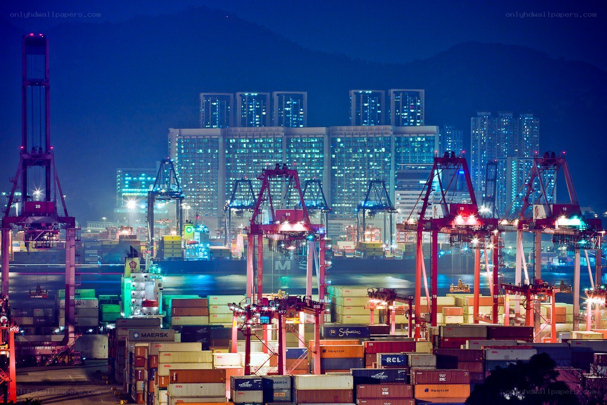 Nighttime port with cranes and containers