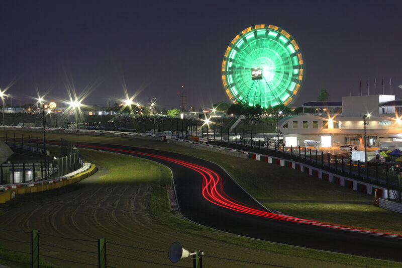 Nighttime race track with Ferris wheel