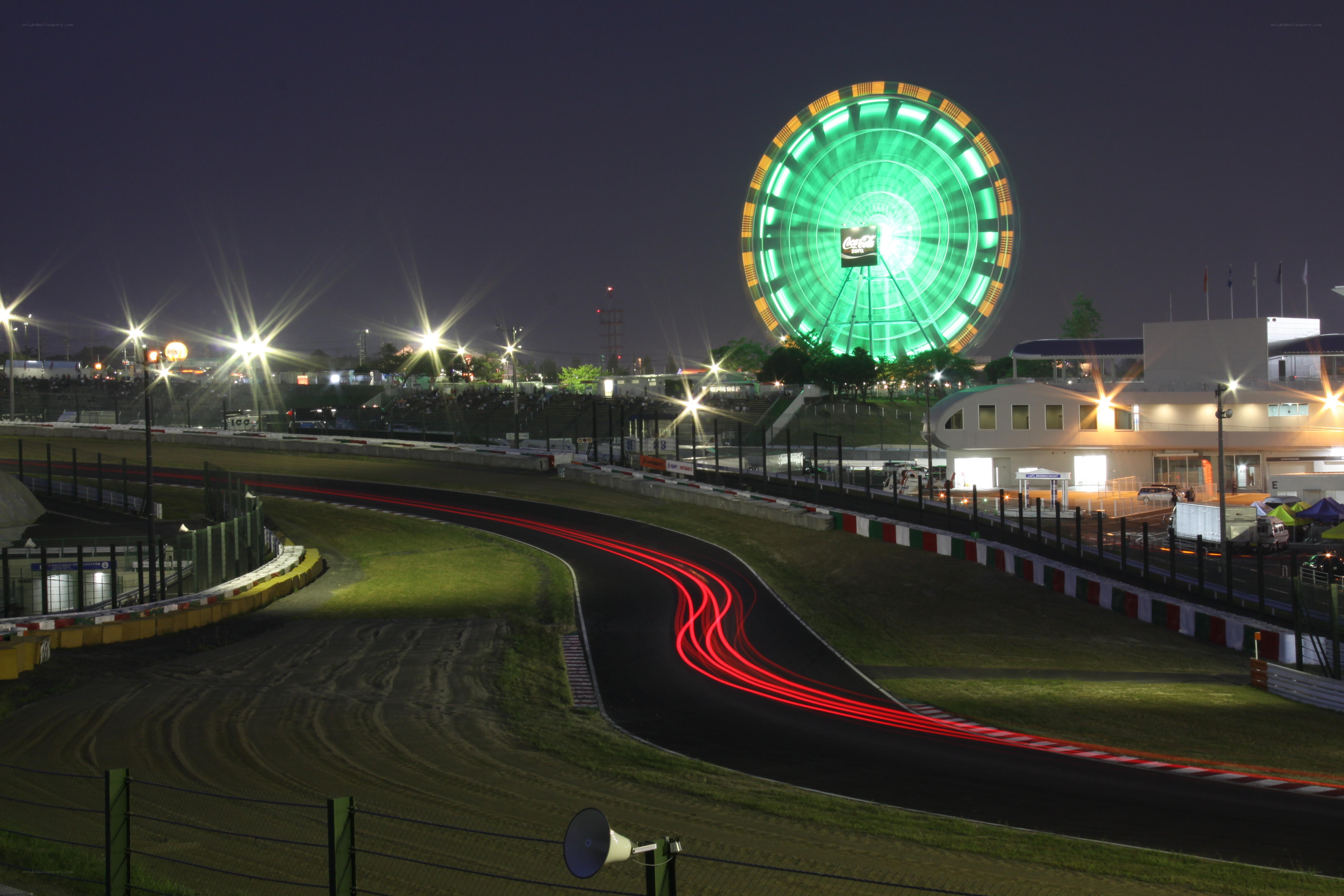 Nighttime race track with Ferris wheel