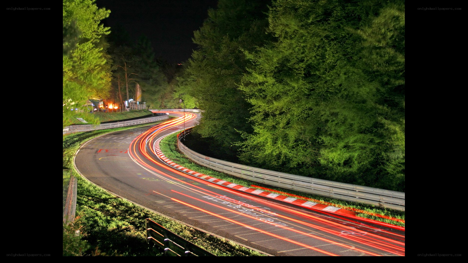 Nighttime race track with light trails
