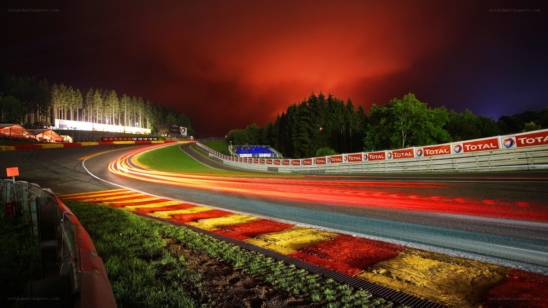Nighttime race track with light trails