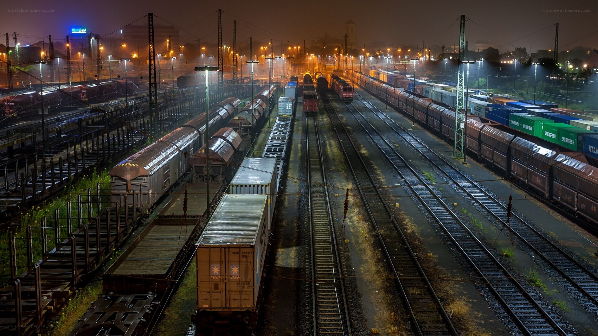 nighttime rail yard with freight trains