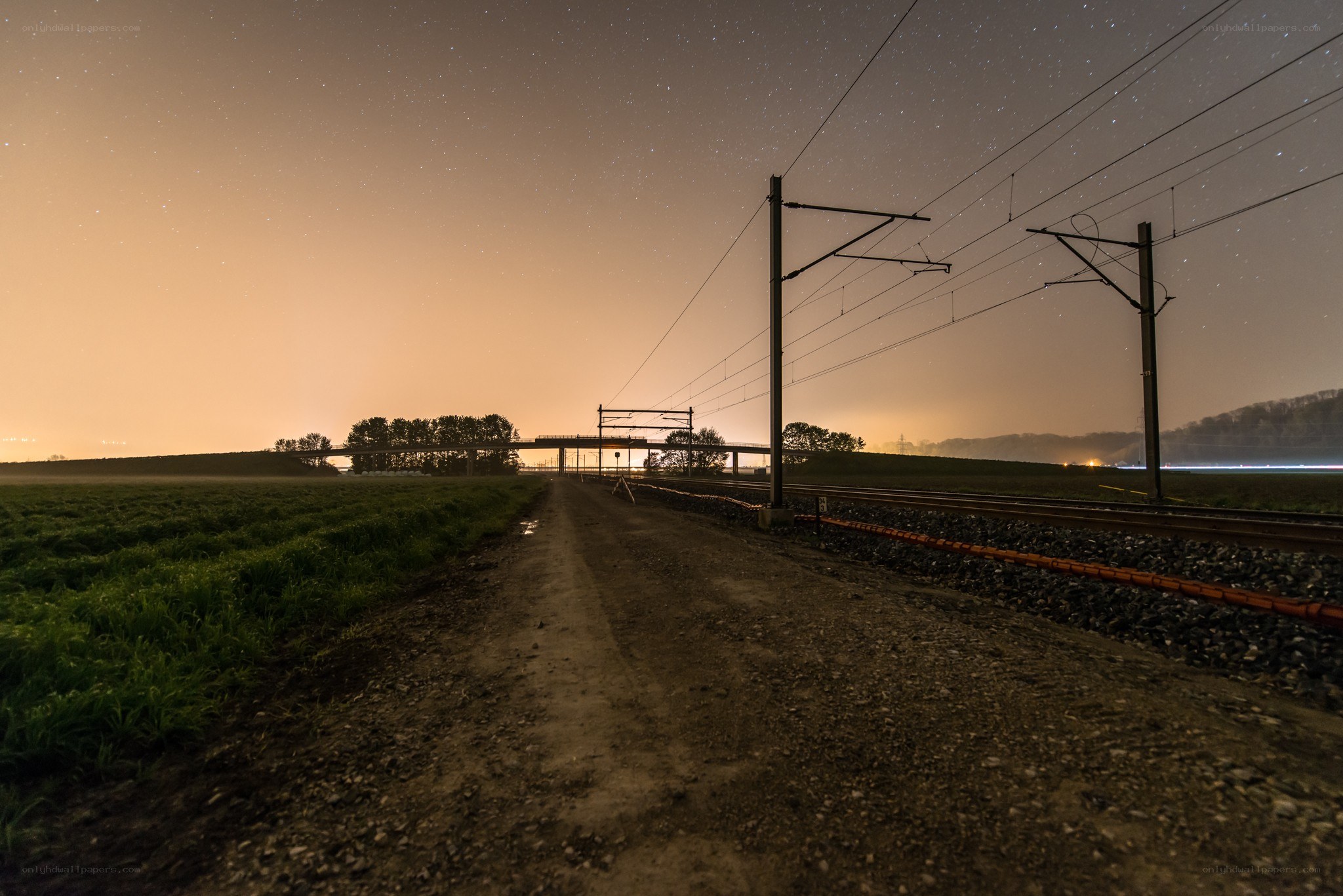 Nighttime railway under starry sky
