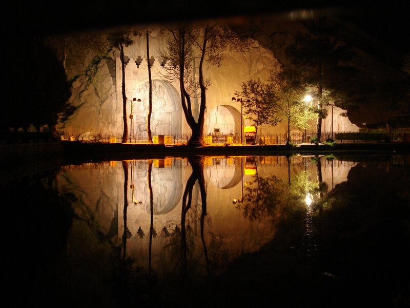 Nighttime reflection of a carved rock facade