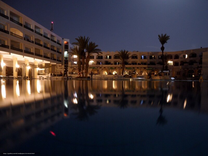 Nighttime resort pool reflection