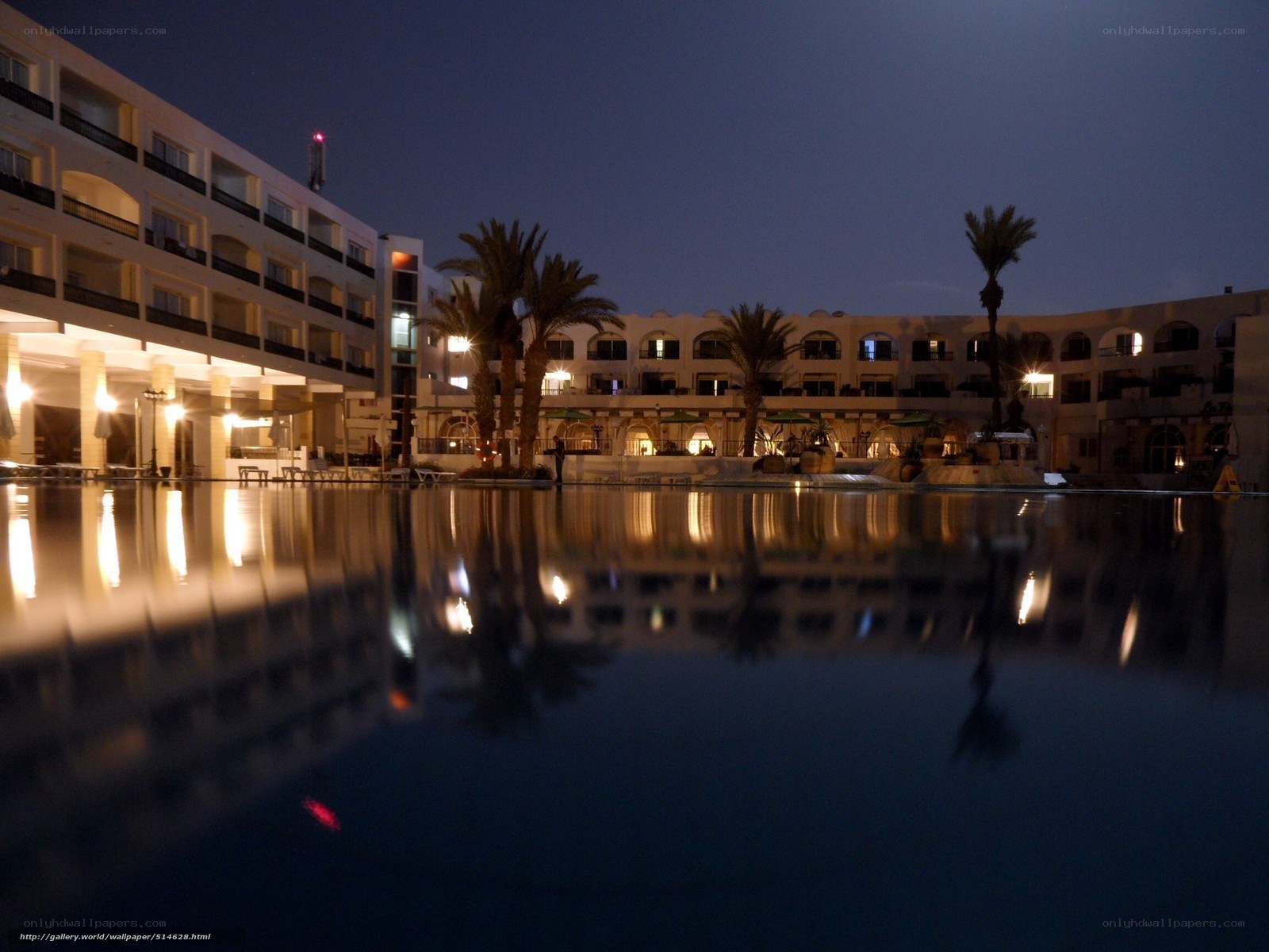 Nighttime resort pool reflection