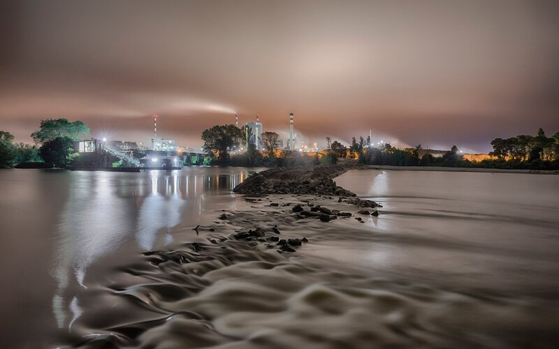 Nighttime river industrial scene