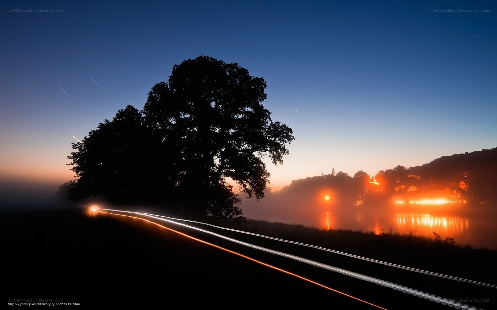 Nighttime river landscape with light trails