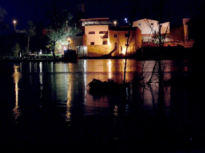 nighttime river scene with buildings