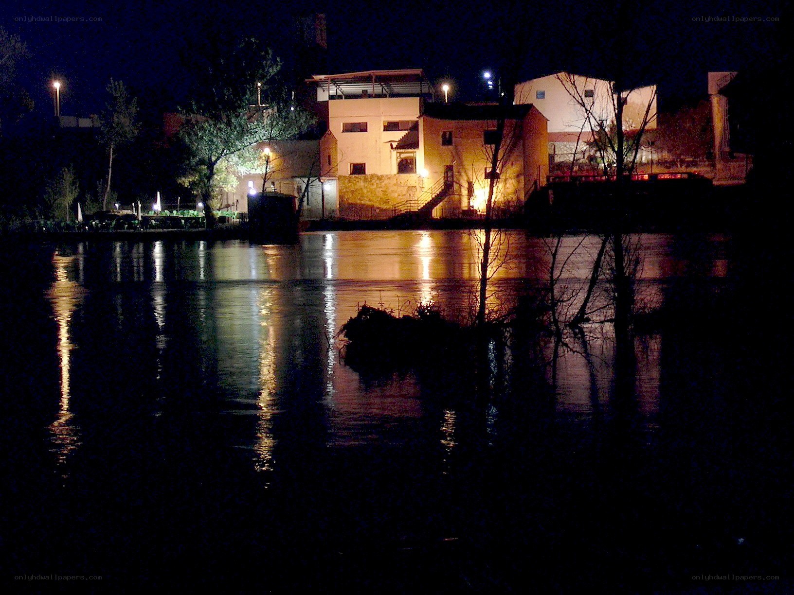 nighttime river scene with buildings