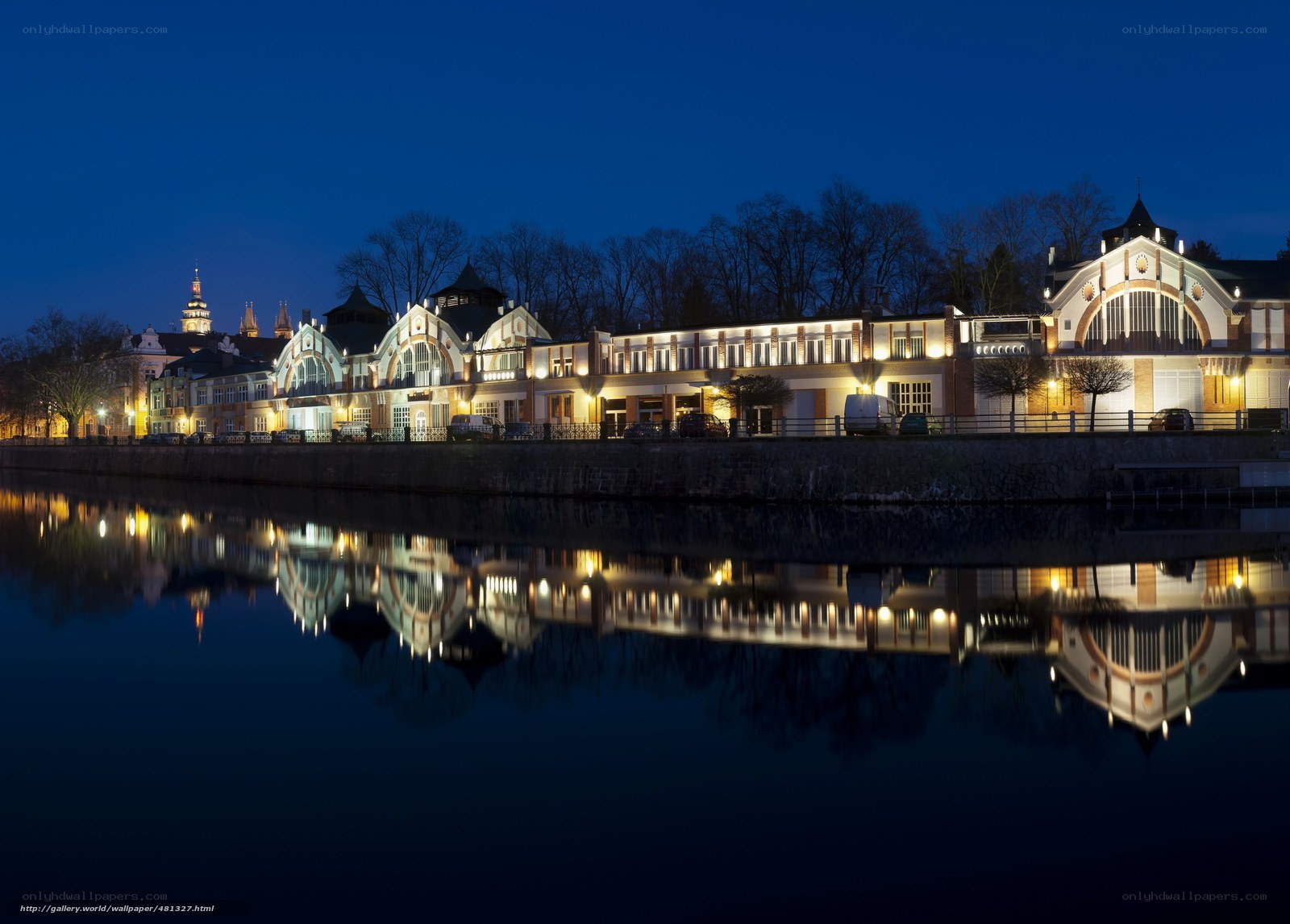 Nighttime riverfront building reflections
