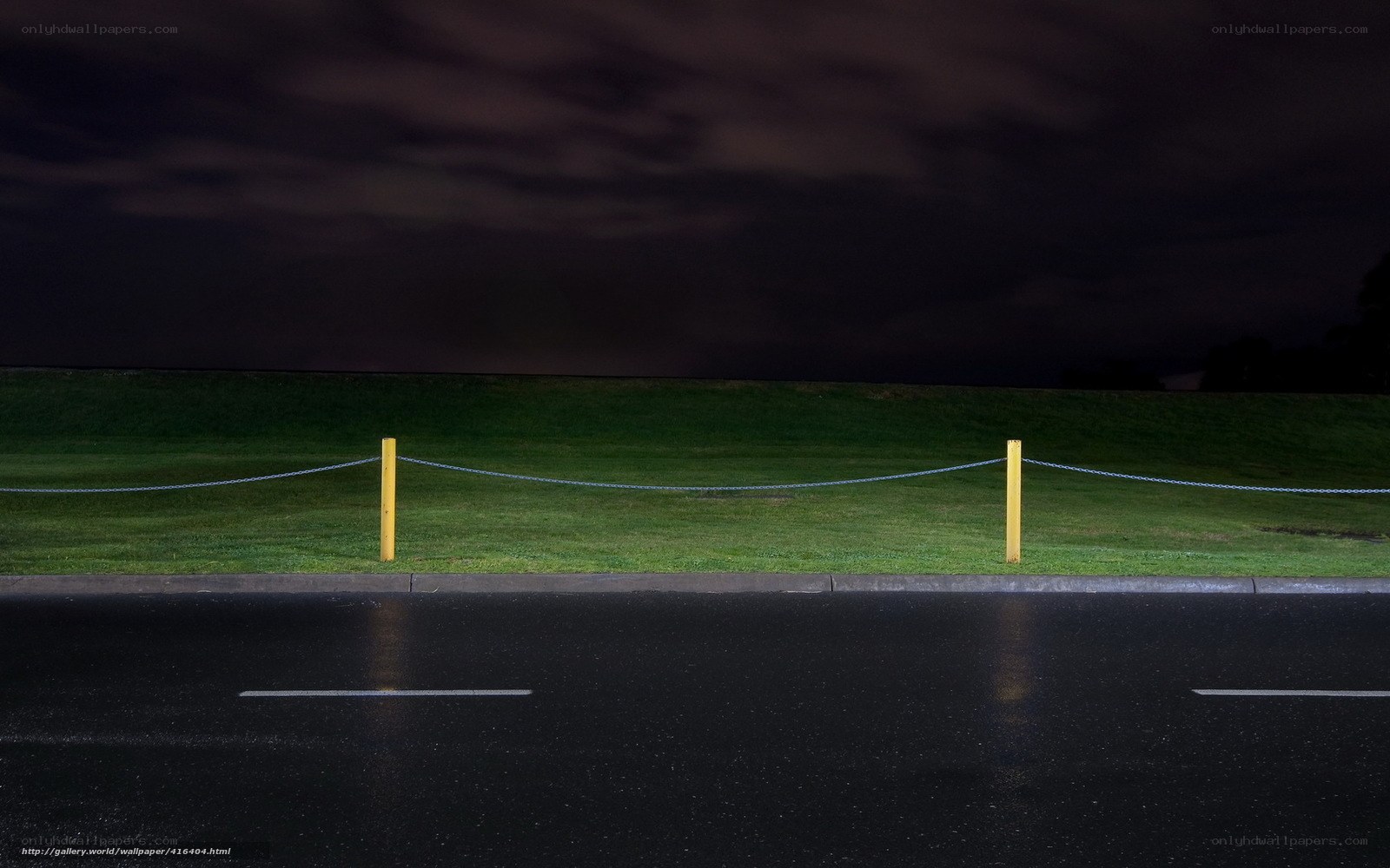 Nighttime road with chain barrier