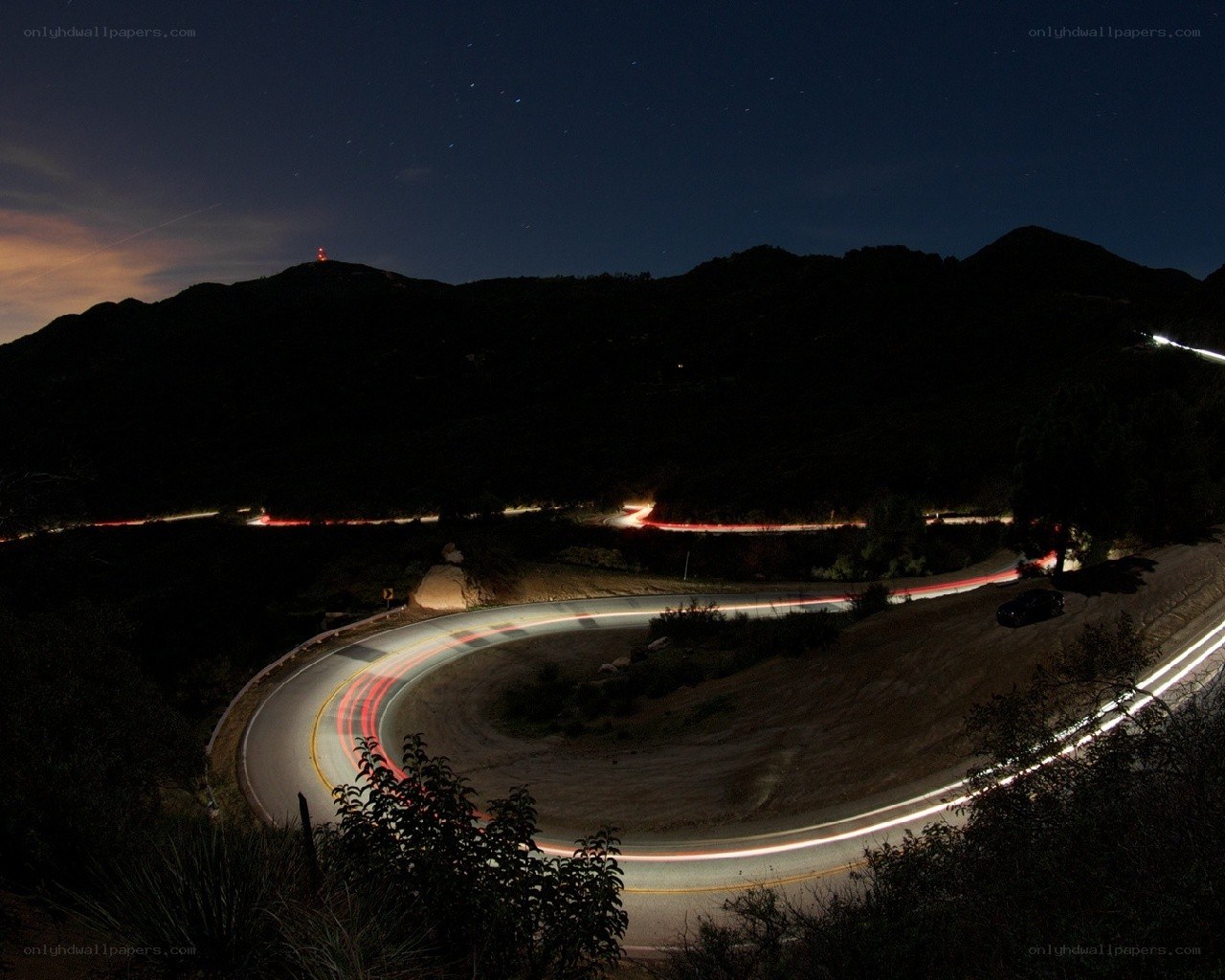 Nighttime road with light trails