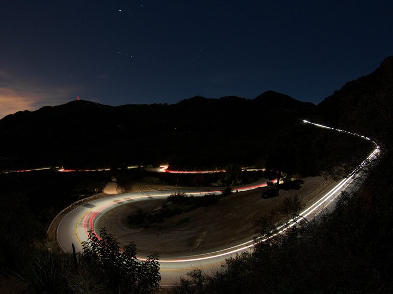 Nighttime road with light trails