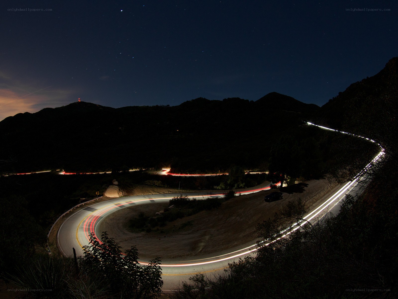 Nighttime road with light trails
