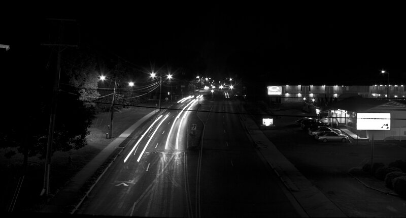 Nighttime road with light trails