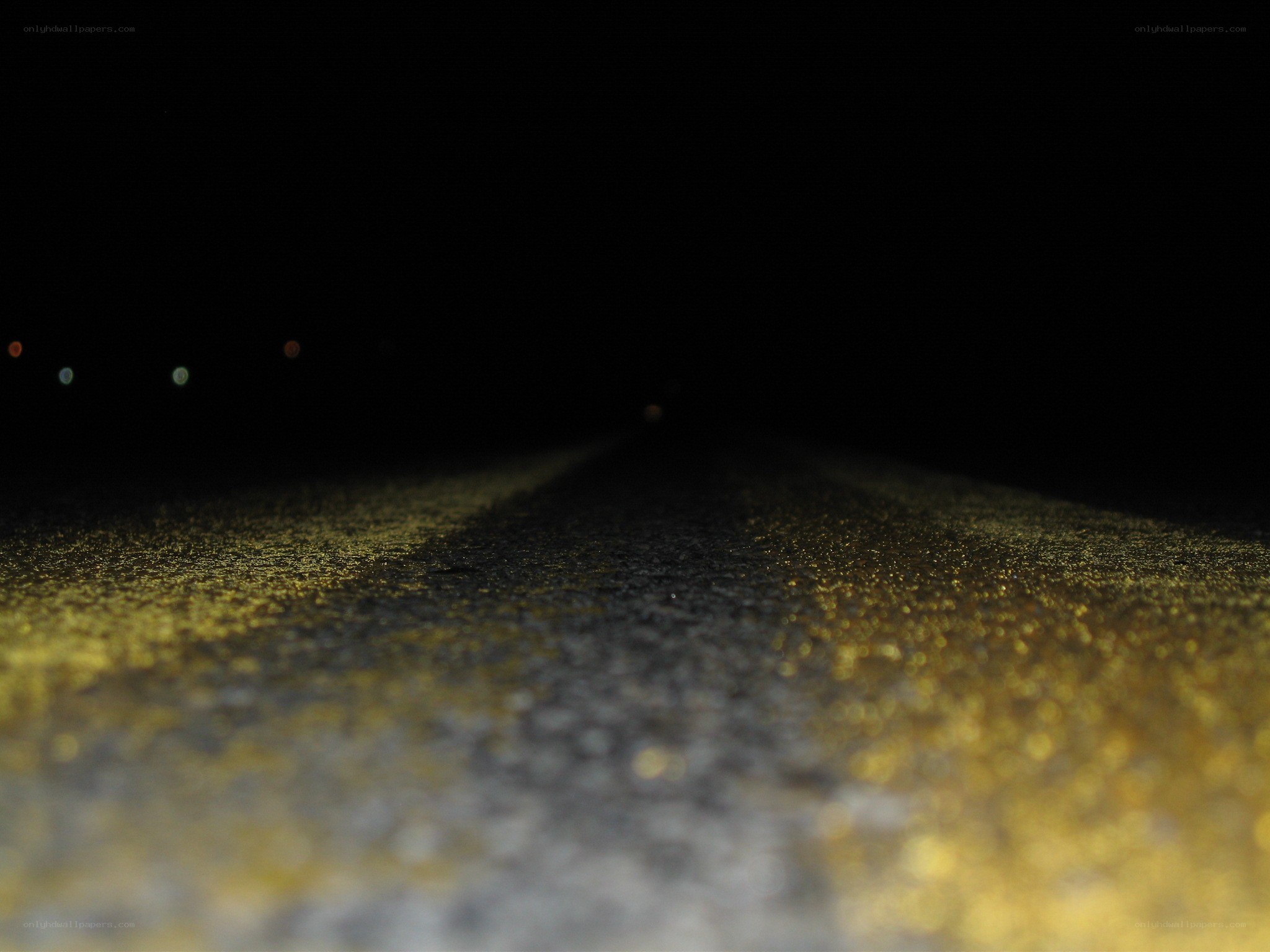 nighttime road with yellow line