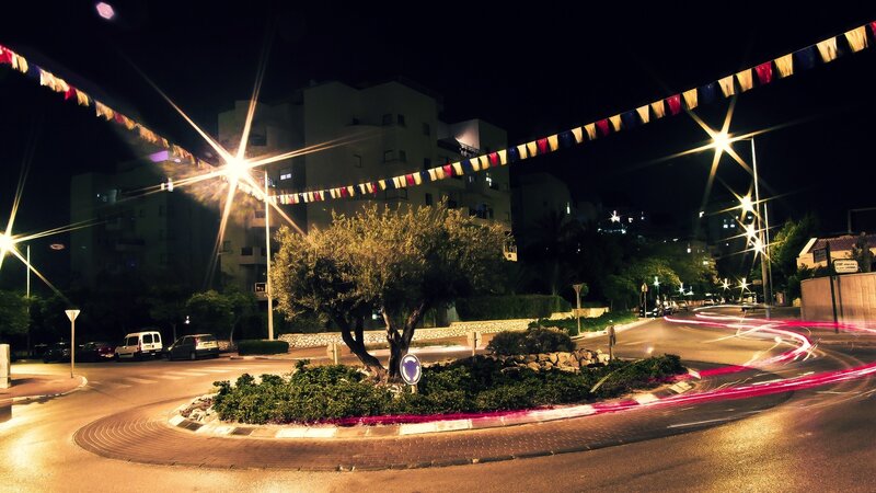 Nighttime roundabout with light trails