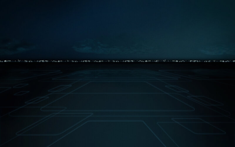 nighttime runway with city lights