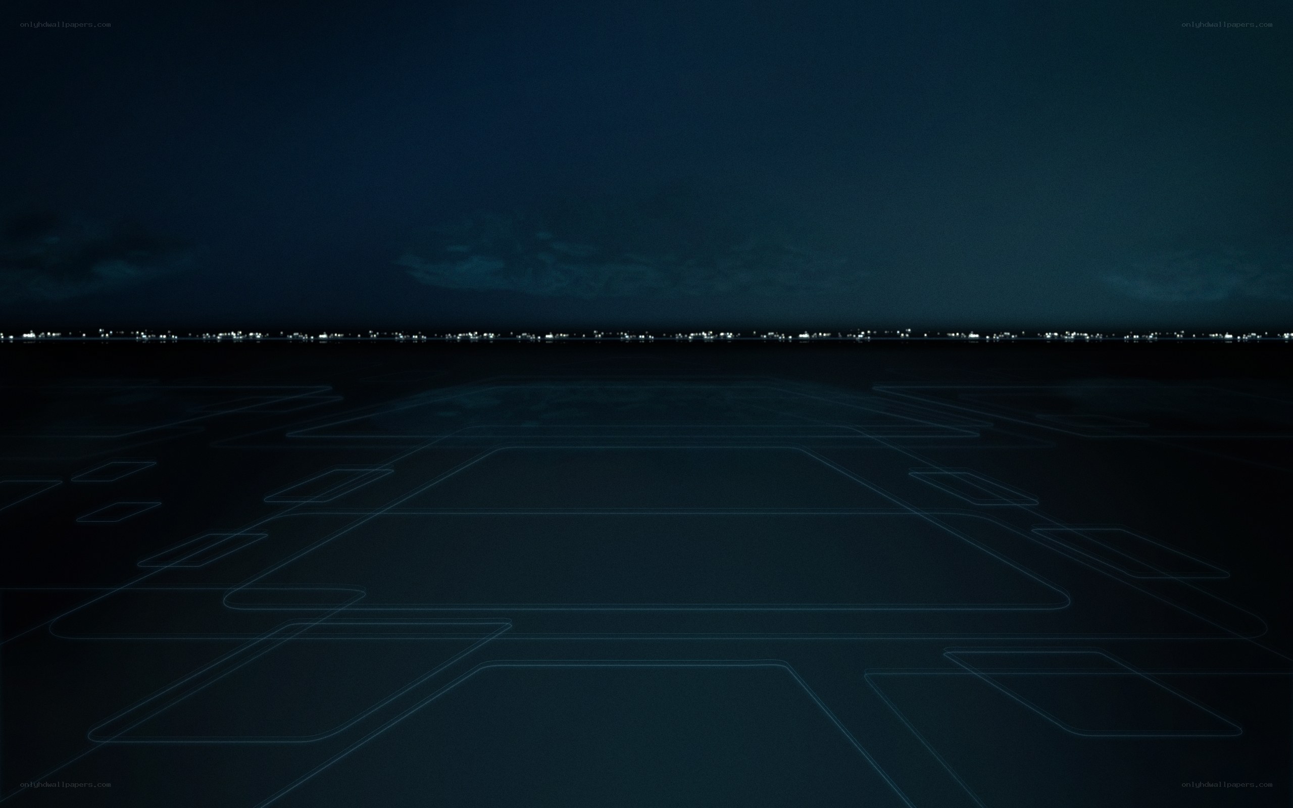 nighttime runway with city lights