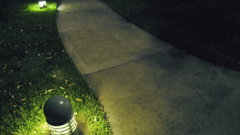 nighttime sidewalk with lights