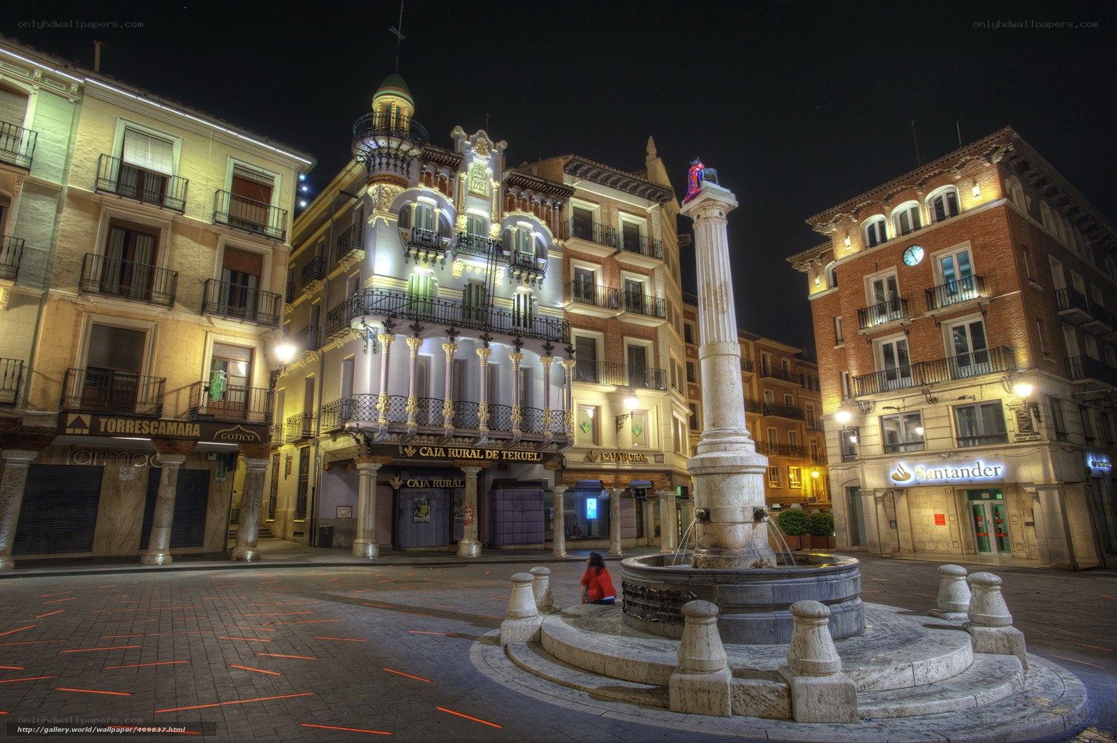 nighttime square with fountain