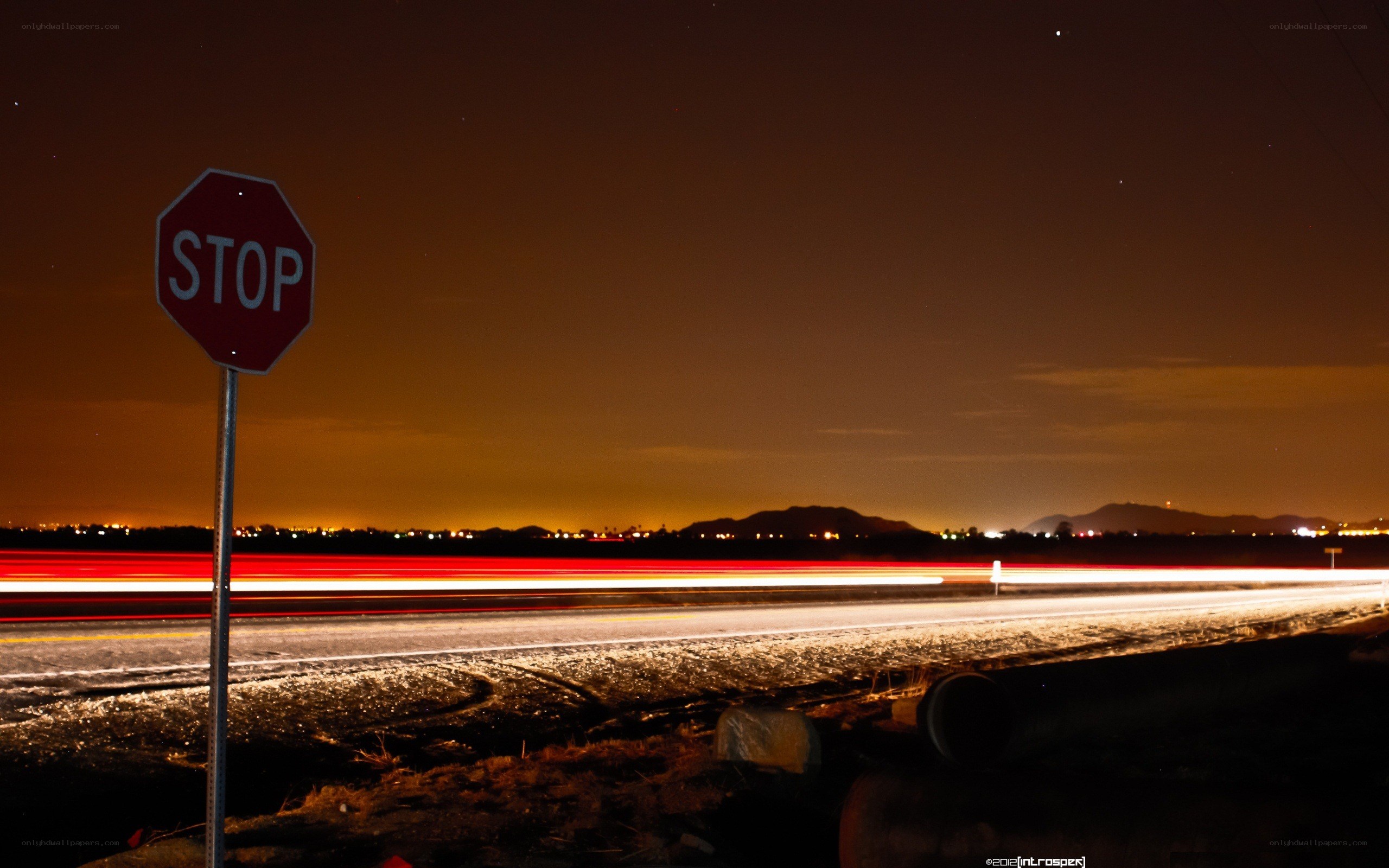 Nighttime stop sign with light trails