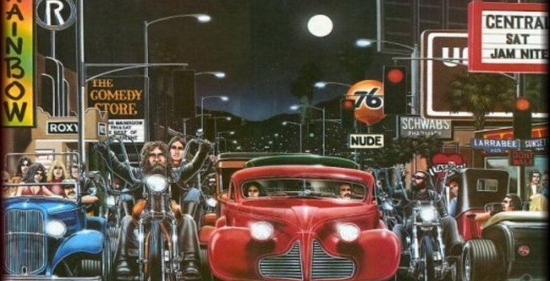 Nighttime street scene with cars and motorcycles