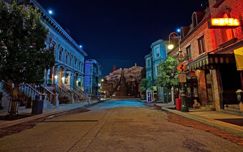Nighttime street scene with Golden Gate Bridge