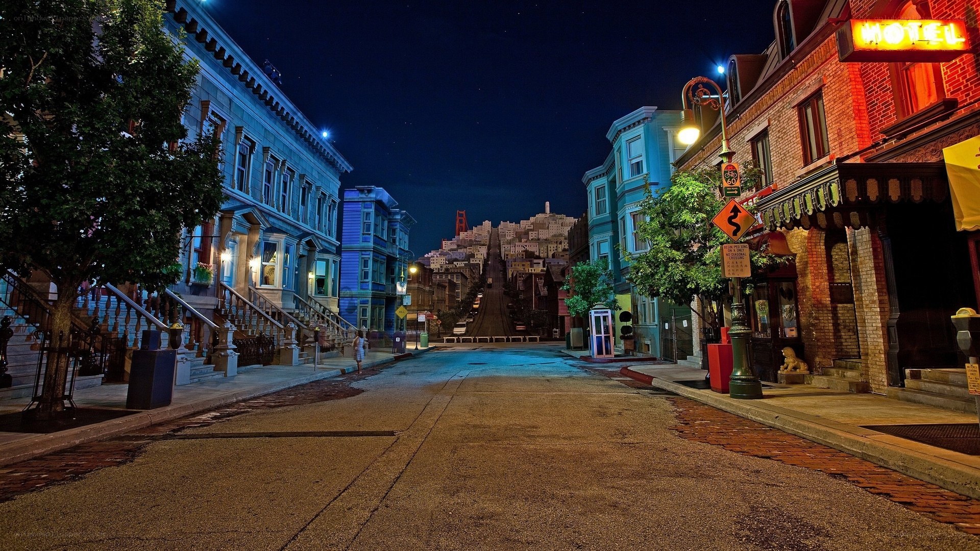 Nighttime street scene with Golden Gate Bridge