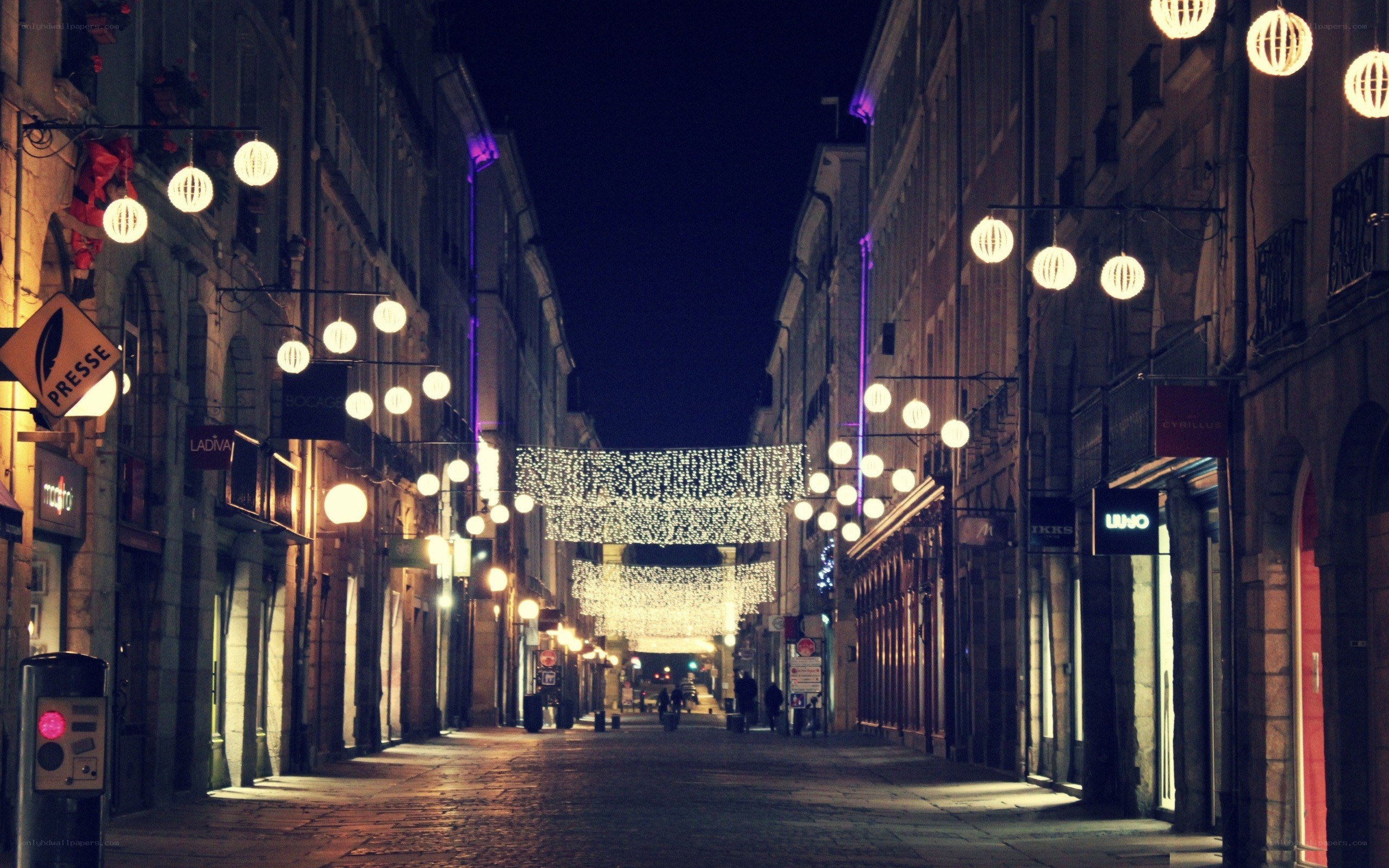 nighttime street with festive lights