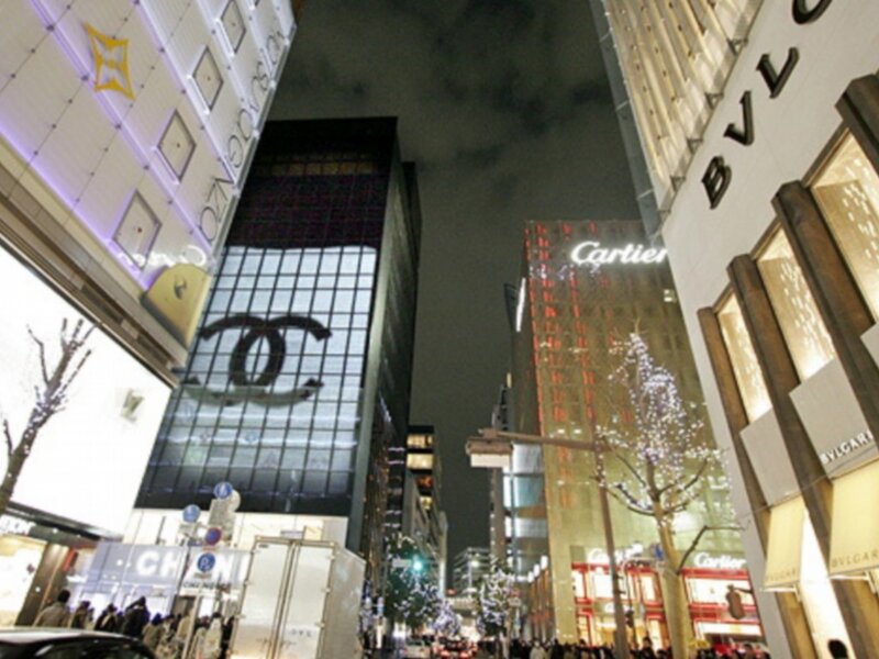 nighttime street with luxury brands