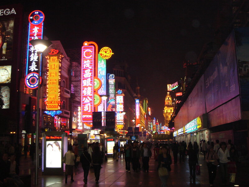 nighttime street with neon signs