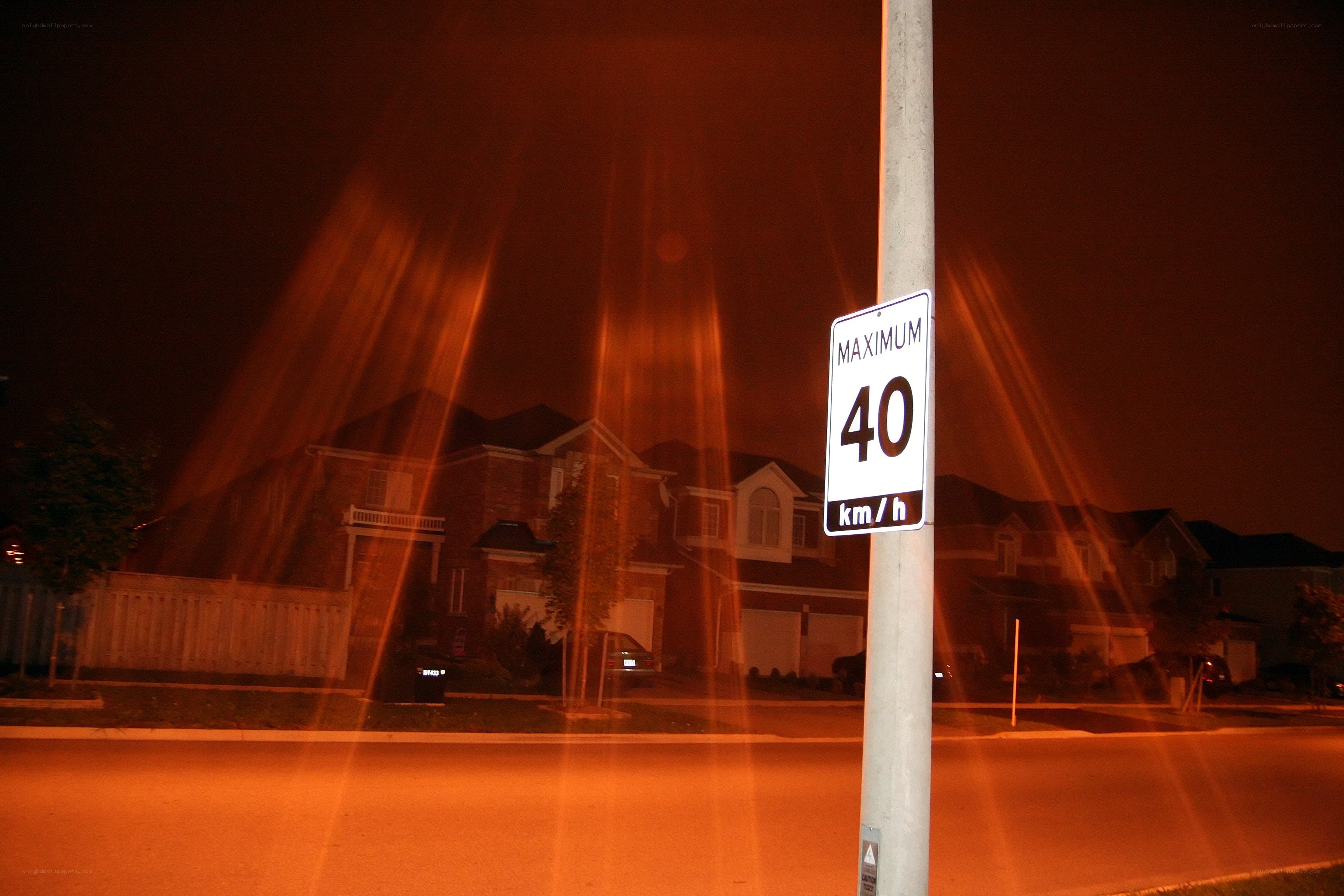 Nighttime street with speed limit sign