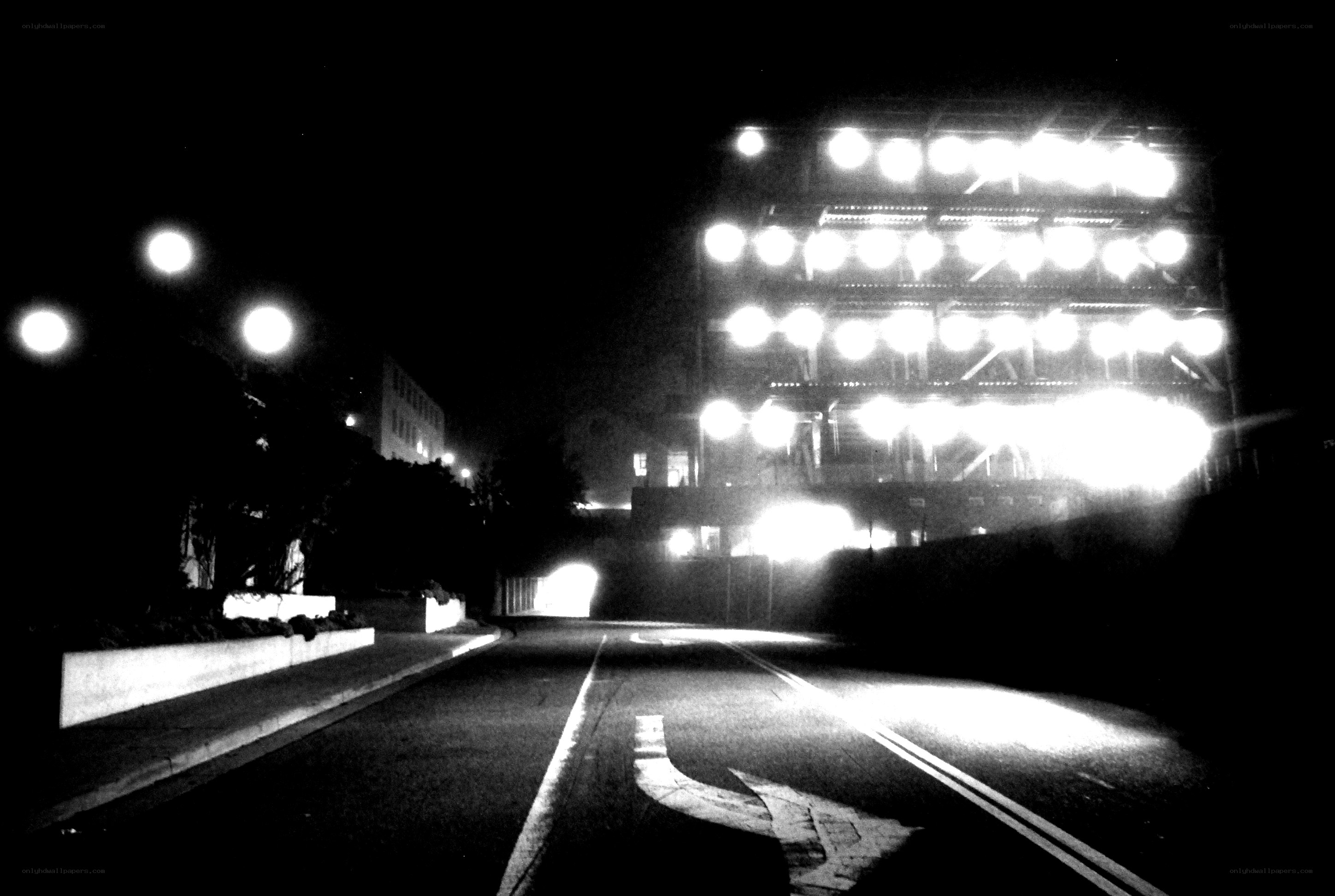 nighttime street with stadium lights