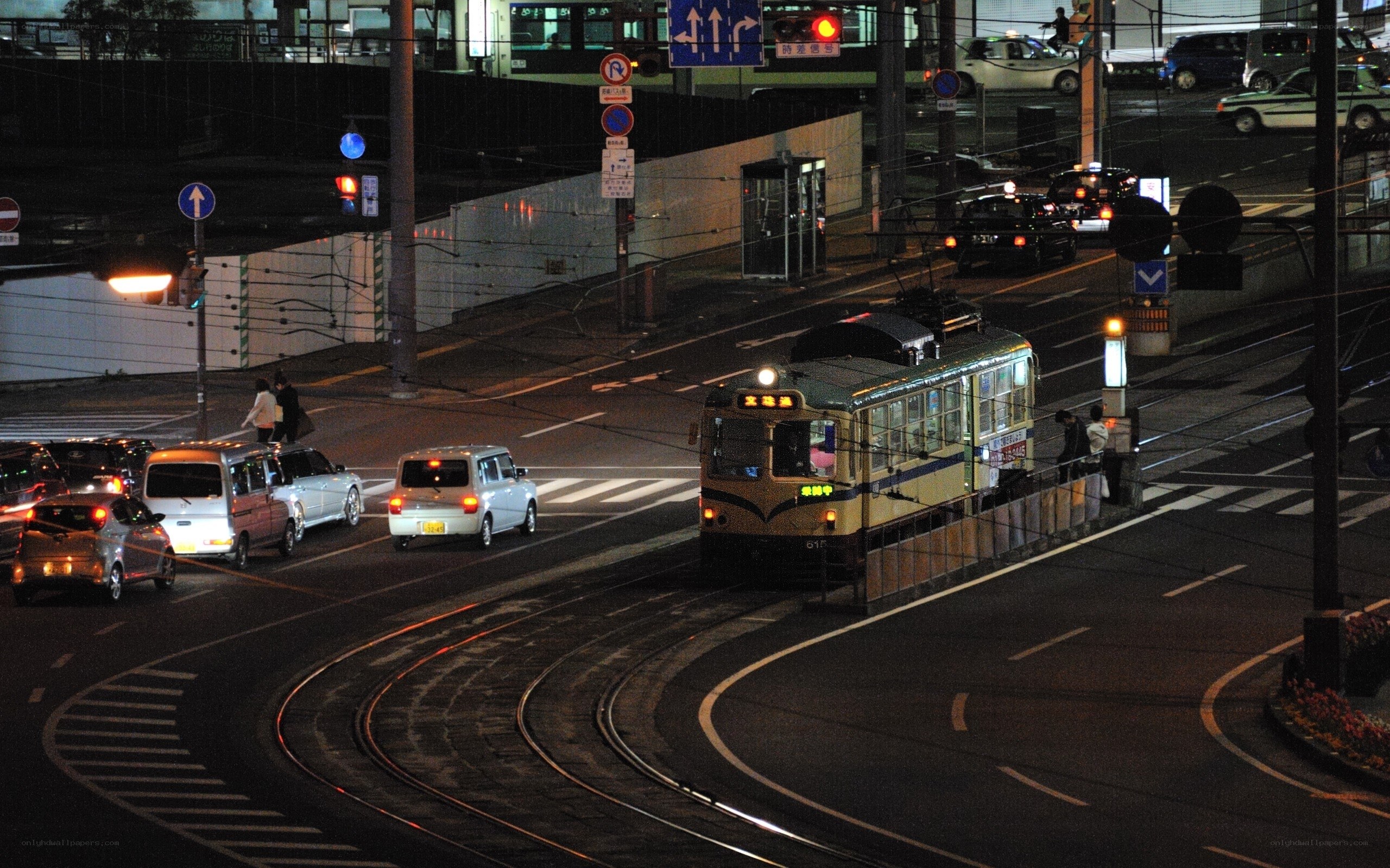Nighttime street with tram and traffic