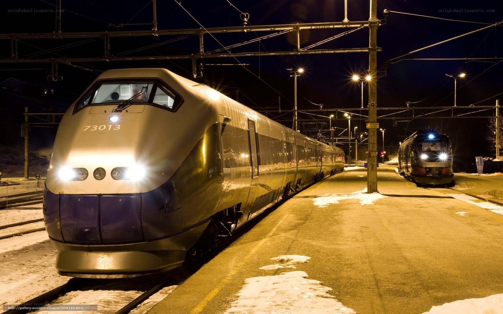 Nighttime train at a snowy station