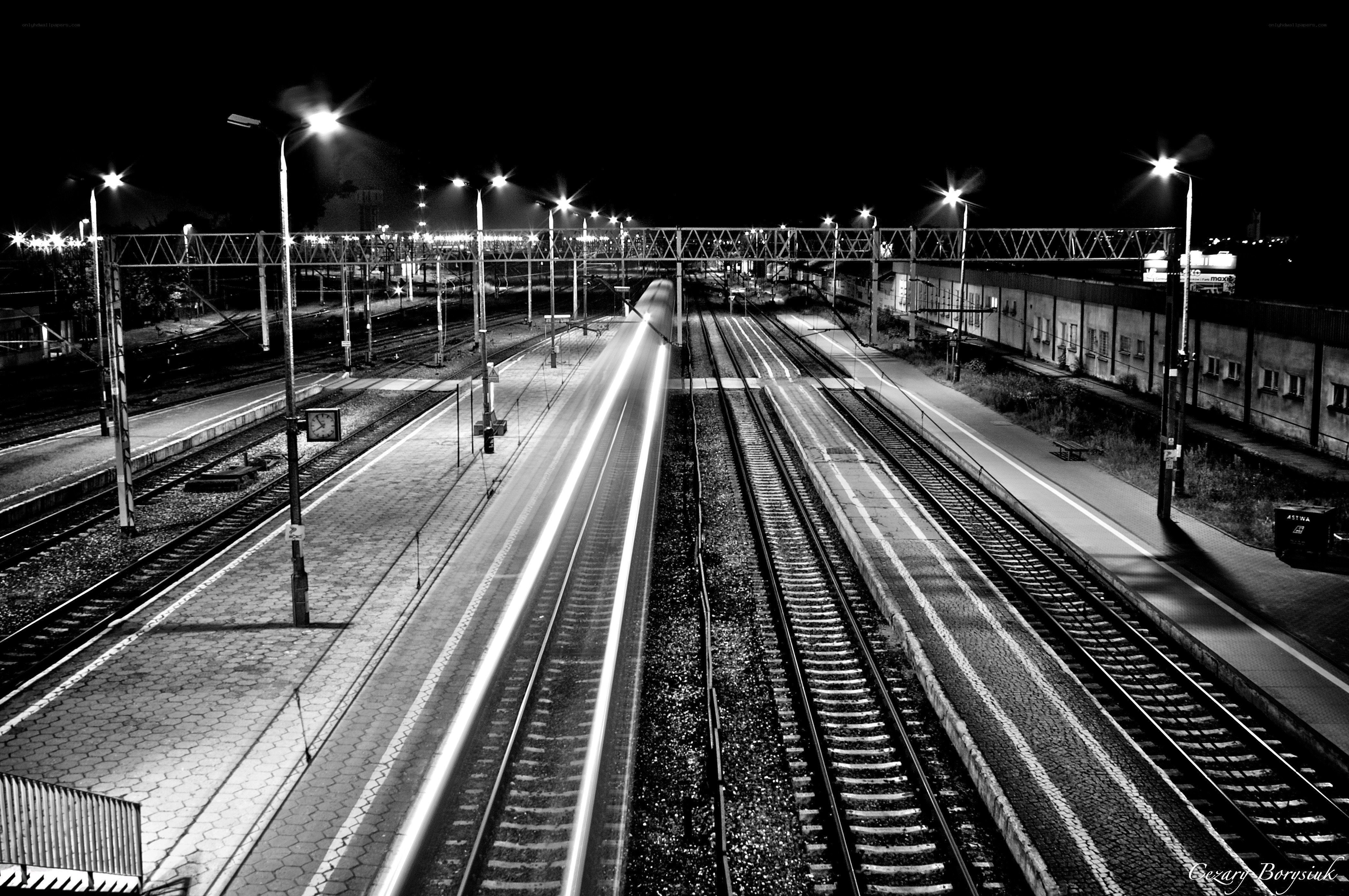 Nighttime train station with light trails