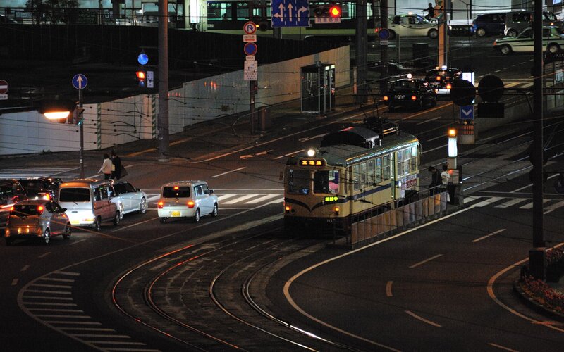 Nighttime tram at city intersection