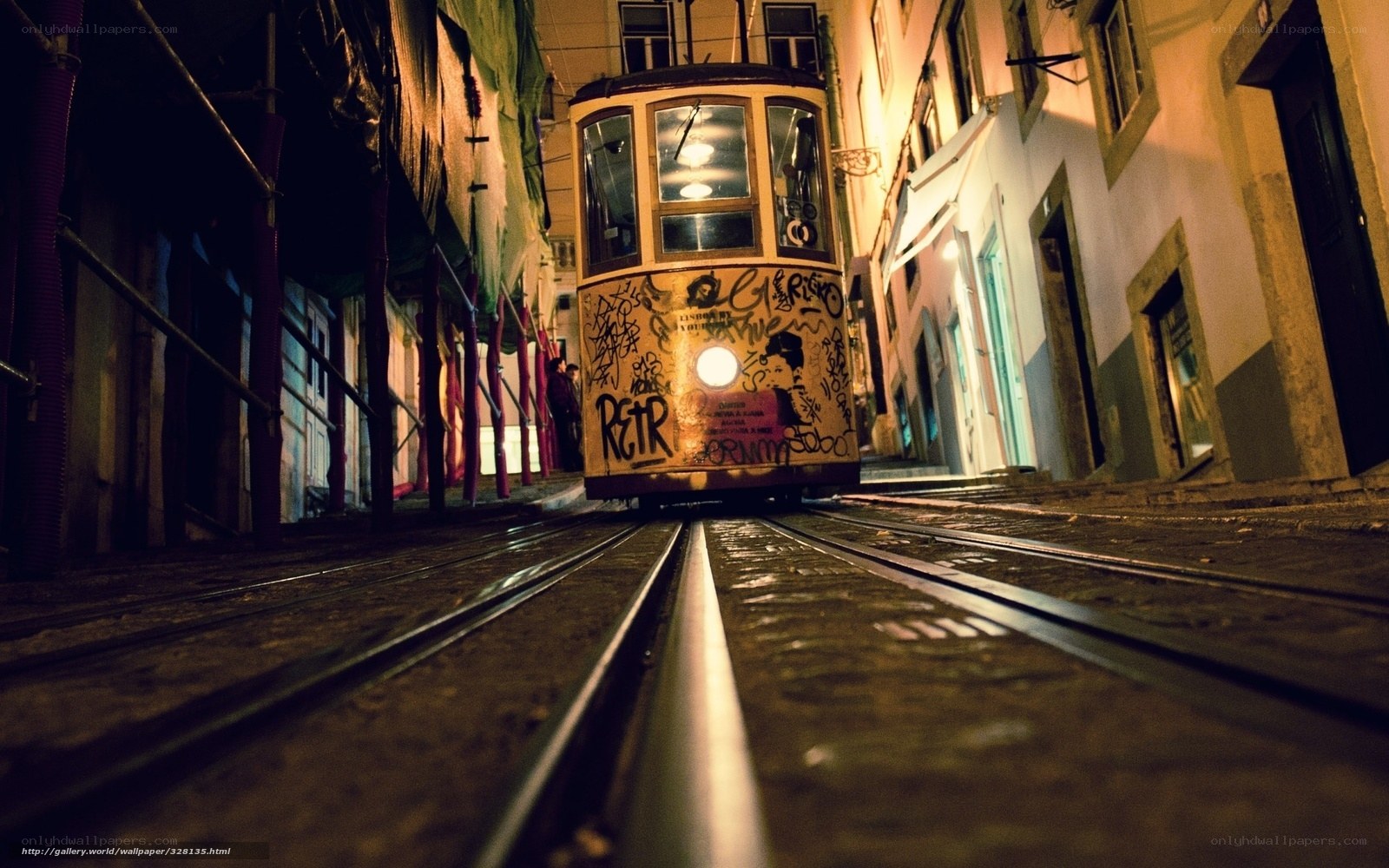 Nighttime tram in narrow street