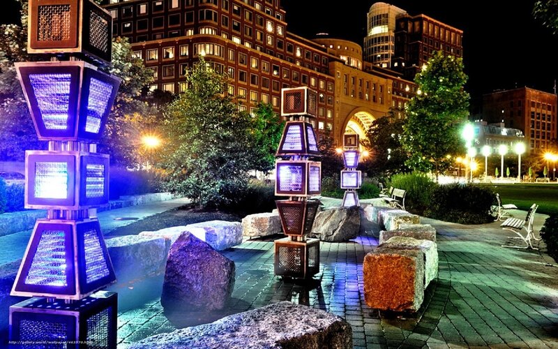 Nighttime urban park with illuminated sculptures