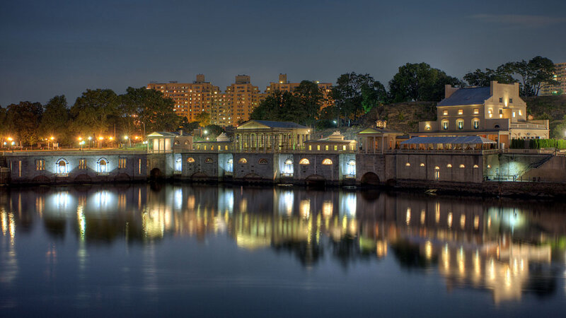nighttime view of a riverfront building