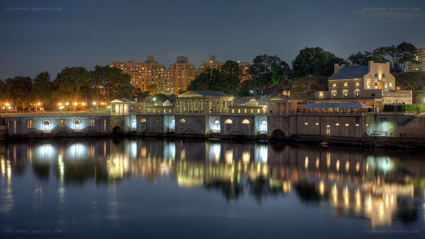 nighttime view of a riverfront building