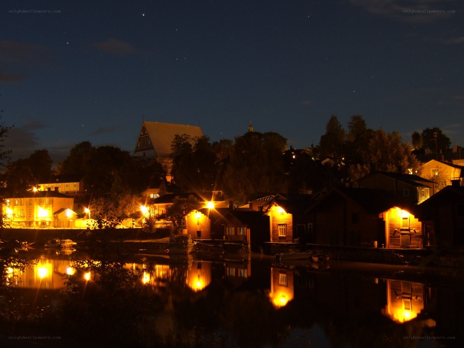 nighttime village by the water